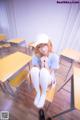 A woman sitting on a chair in a classroom.